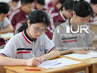 Grade three high school students who are about to take the National college entrance examination are reviewing in a self-study class at Gany...