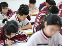 Grade three high school students who are about to take the National college entrance examination are reviewing in a self-study class at Gany...