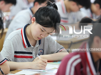 Grade three high school students who are about to take the National college entrance examination are reviewing in a self-study class at Gany...