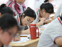 Grade three high school students who are about to take the National college entrance examination are reviewing in a self-study class at Gany...