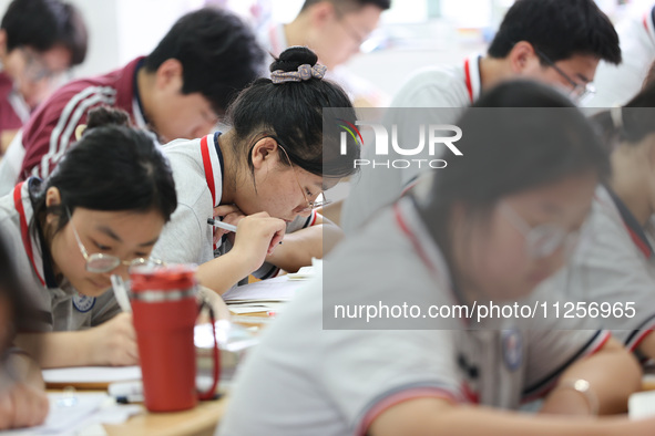 Grade three high school students who are about to take the National college entrance examination are reviewing in a self-study class at Gany...