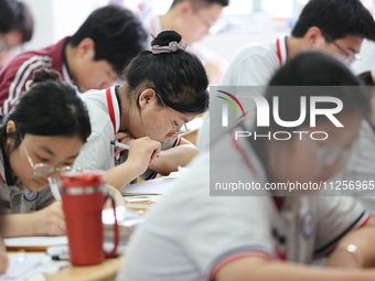 Grade three high school students who are about to take the National college entrance examination are reviewing in a self-study class at Gany...