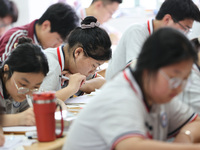 Grade three high school students who are about to take the National college entrance examination are reviewing in a self-study class at Gany...