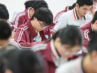 Grade three high school students who are about to take the National college entrance examination are reviewing in a self-study class at Gany...