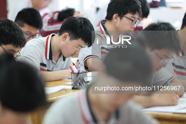 Grade three high school students who are about to take the National college entrance examination are reviewing in a self-study class at Gany...