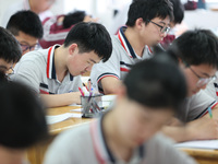 Grade three high school students who are about to take the National college entrance examination are reviewing in a self-study class at Gany...