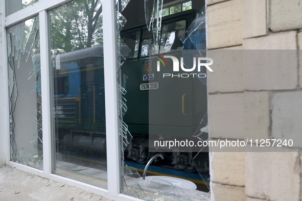 A train at the Junior Southern Railway, a children's railway, is being reflected in the shards of a broken window after being damaged by Rus...