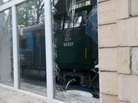 A train at the Junior Southern Railway, a children's railway, is being reflected in the shards of a broken window after being damaged by Rus...