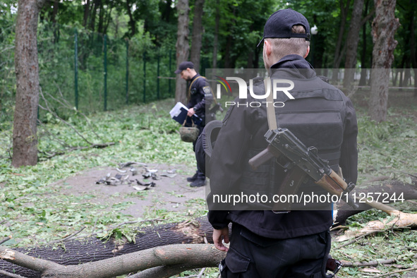 Law enforcers are collecting the fragments of a Russian explosive found after shelling in Kharkiv, Ukraine, on May 19, 2024. NO USE RUSSIA....