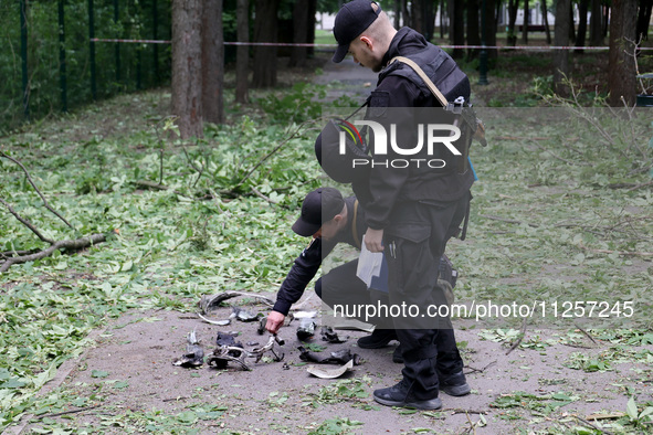 Law enforcers are collecting the fragments of a Russian explosive found after shelling in Kharkiv, Ukraine, on May 19, 2024. NO USE RUSSIA....