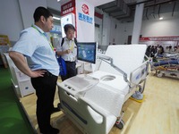 Visitors are visiting an ''electric nursing bed'' at the 32nd China International Health Industry Expo in Beijing, China, on May 20, 2024. (