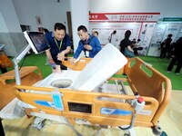 Visitors are visiting a ''Multi-functional intelligent nursing bed'' at the 32nd China International Health Industry Expo in Beijing, China,...