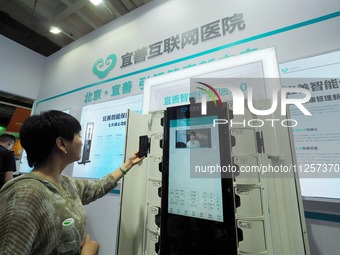 Visitors are visiting a ''smart Health care'' system at the 32nd China International Health Industry Expo in Beijing, China, on May 20, 2024...