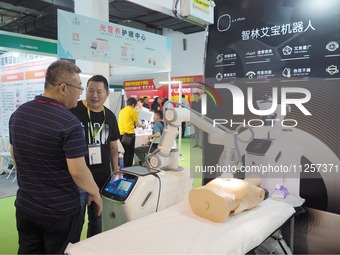 Visitors are visiting a ''physiotherapy robot'' at the 32nd China International Health Industry Expo in Beijing, China, on May 20, 2024. (