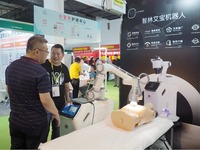 Visitors are visiting a ''physiotherapy robot'' at the 32nd China International Health Industry Expo in Beijing, China, on May 20, 2024. (