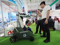 Visitors are visiting a ''lower limb rehabilitation robot'' at the 32nd China International Health Industry Expo in Beijing, China, on May 2...