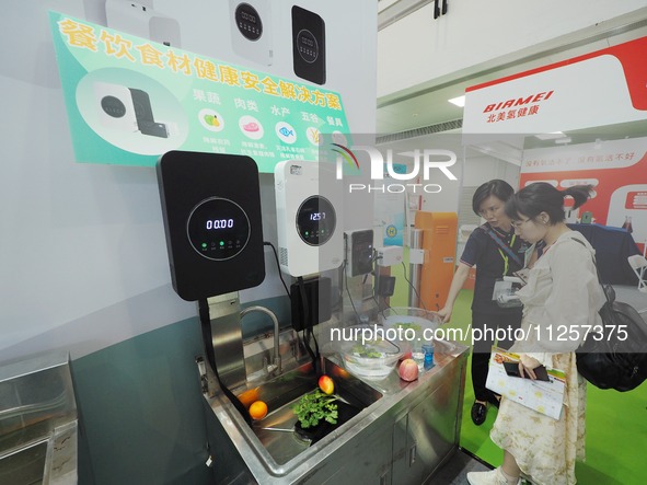 Visitors are visiting a ''food ingredients purification machine'' at the 32nd China International Health Industry Expo in Beijing, China, on...