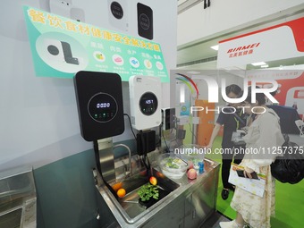 Visitors are visiting a ''food ingredients purification machine'' at the 32nd China International Health Industry Expo in Beijing, China, on...