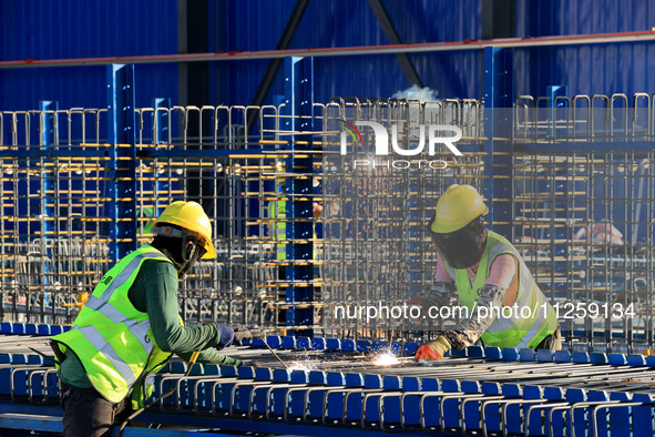 Workers are working at the construction site of a highway in Jiangbian village, Liuzhou city, South China's Guangxi Zhuang Autonomous region...