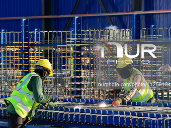 Workers are working at the construction site of a highway in Jiangbian village, Liuzhou city, South China's Guangxi Zhuang Autonomous region...