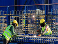 Workers are working at the construction site of a highway in Jiangbian village, Liuzhou city, South China's Guangxi Zhuang Autonomous region...