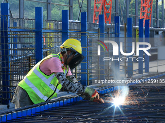 Workers are working at the construction site of a highway in Jiangbian village, Liuzhou city, South China's Guangxi Zhuang Autonomous region...