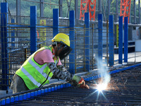 Workers are working at the construction site of a highway in Jiangbian village, Liuzhou city, South China's Guangxi Zhuang Autonomous region...