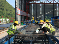 Workers are working at the construction site of a highway in Jiangbian village, Liuzhou city, South China's Guangxi Zhuang Autonomous region...