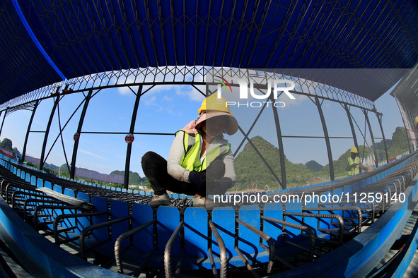 Workers are working at the construction site of a highway in Jiangbian village, Liuzhou city, South China's Guangxi Zhuang Autonomous region...