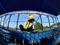 Workers are working at the construction site of a highway in Jiangbian village, Liuzhou city, South China's Guangxi Zhuang Autonomous region...