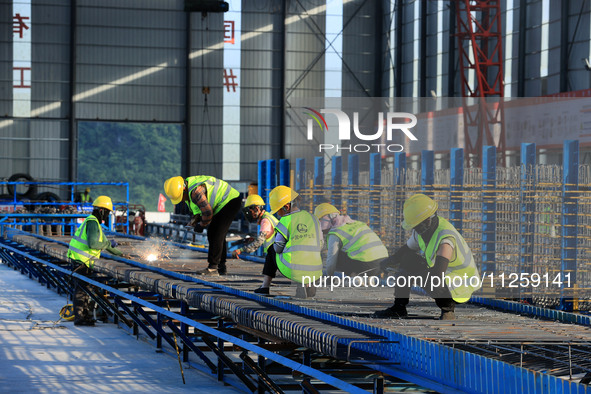 Workers are working at the construction site of a highway in Jiangbian village, Liuzhou city, South China's Guangxi Zhuang Autonomous region...