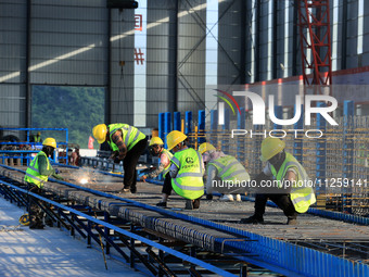 Workers are working at the construction site of a highway in Jiangbian village, Liuzhou city, South China's Guangxi Zhuang Autonomous region...