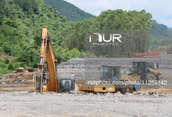 Workers are working at the construction site of a highway in Jiangbian village, Liuzhou city, South China's Guangxi Zhuang Autonomous region...