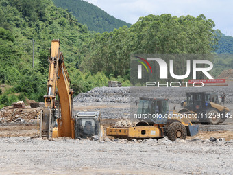 Workers are working at the construction site of a highway in Jiangbian village, Liuzhou city, South China's Guangxi Zhuang Autonomous region...