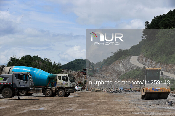 Workers are working at the construction site of a highway in Jiangbian village, Liuzhou city, South China's Guangxi Zhuang Autonomous region...