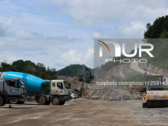 Workers are working at the construction site of a highway in Jiangbian village, Liuzhou city, South China's Guangxi Zhuang Autonomous region...