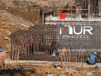 Workers are working at the construction site of a highway in Jiangbian village, Liuzhou city, South China's Guangxi Zhuang Autonomous region...