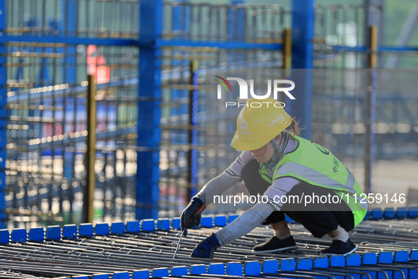 Workers are working at the construction site of a highway in Jiangbian village, Liuzhou city, South China's Guangxi Zhuang Autonomous region...