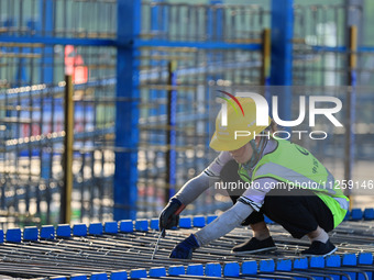 Workers are working at the construction site of a highway in Jiangbian village, Liuzhou city, South China's Guangxi Zhuang Autonomous region...