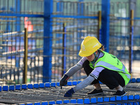 Workers are working at the construction site of a highway in Jiangbian village, Liuzhou city, South China's Guangxi Zhuang Autonomous region...