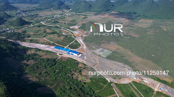 Workers are working at the construction site of a highway in Jiangbian village, Liuzhou city, South China's Guangxi Zhuang Autonomous region...