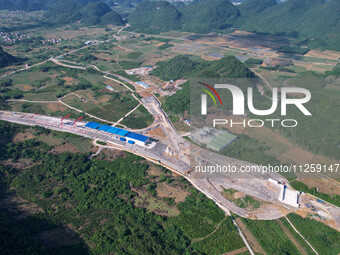 Workers are working at the construction site of a highway in Jiangbian village, Liuzhou city, South China's Guangxi Zhuang Autonomous region...