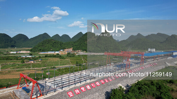 Workers are working at the construction site of a highway in Jiangbian village, Liuzhou city, South China's Guangxi Zhuang Autonomous region...