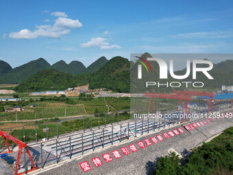 Workers are working at the construction site of a highway in Jiangbian village, Liuzhou city, South China's Guangxi Zhuang Autonomous region...