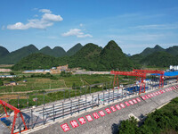 Workers are working at the construction site of a highway in Jiangbian village, Liuzhou city, South China's Guangxi Zhuang Autonomous region...