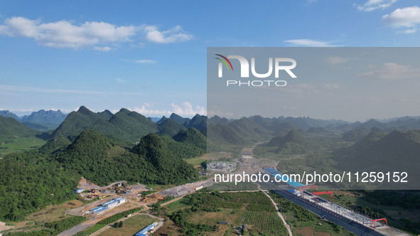 Workers are working at the construction site of a highway in Jiangbian village, Liuzhou city, South China's Guangxi Zhuang Autonomous region...