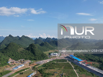 Workers are working at the construction site of a highway in Jiangbian village, Liuzhou city, South China's Guangxi Zhuang Autonomous region...