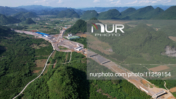 Workers are working at the construction site of a highway in Jiangbian village, Liuzhou city, South China's Guangxi Zhuang Autonomous region...