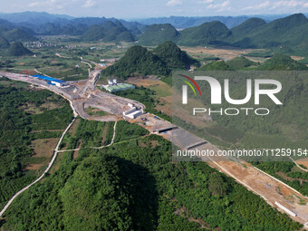 Workers are working at the construction site of a highway in Jiangbian village, Liuzhou city, South China's Guangxi Zhuang Autonomous region...