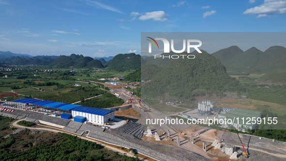 Workers are working at the construction site of a highway in Jiangbian village, Liuzhou city, South China's Guangxi Zhuang Autonomous region...